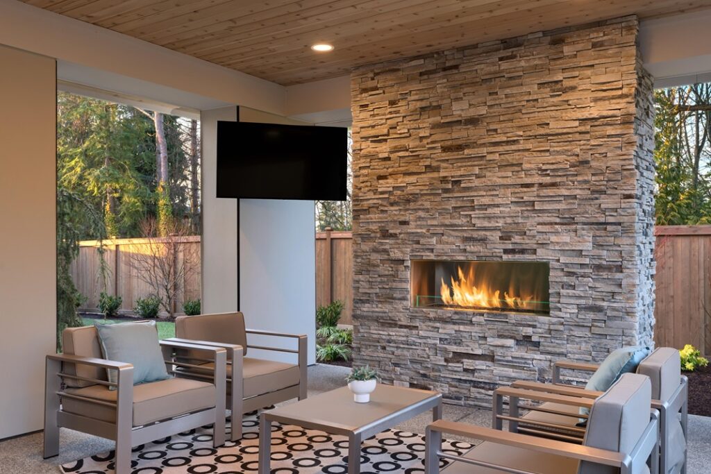 Luxury,Outdoor,Relaxing,Living,Room,With,Large,Stone,Fireplace,,Tv,